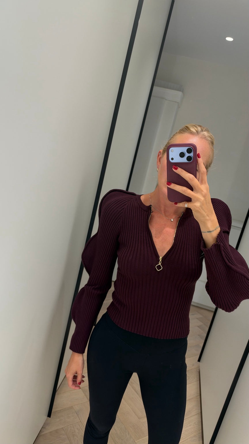 Burgundy ribbed zip-neck knit with puff sleeves
